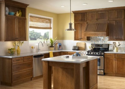 This renovated kitchen showcases cheerful warmth and casual charm with its bright finishes and cozy farmhouse appeal.