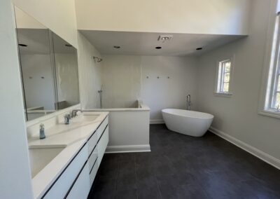This serene bathroom retreat pairs minimalist lines with spa-like luxury for a clean, calming escape.