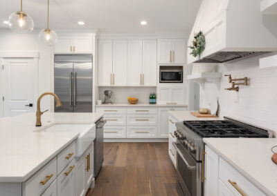 This showstopping kitchen radiates effortless luxury and timeless sophistication with its bright palette, brass accents, and flawless modern design.